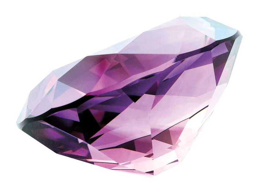 Purple gemstone cut in a multifaceted shape reflecting light on a white background