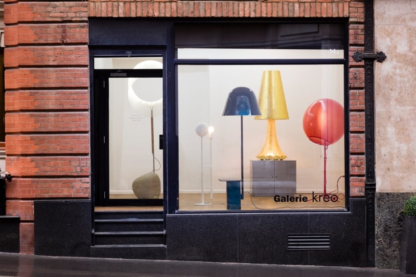 Storefront of Galerie Kreo with a display of colorful modern lamps and sculptures in the window.