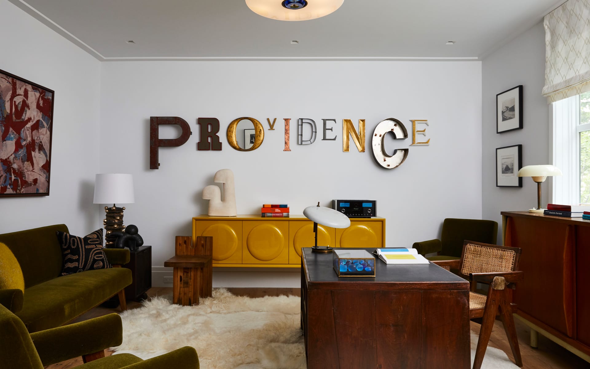 Stylish living room with unique "Providence" wall art, vintage furniture, and patterned decor elements.
