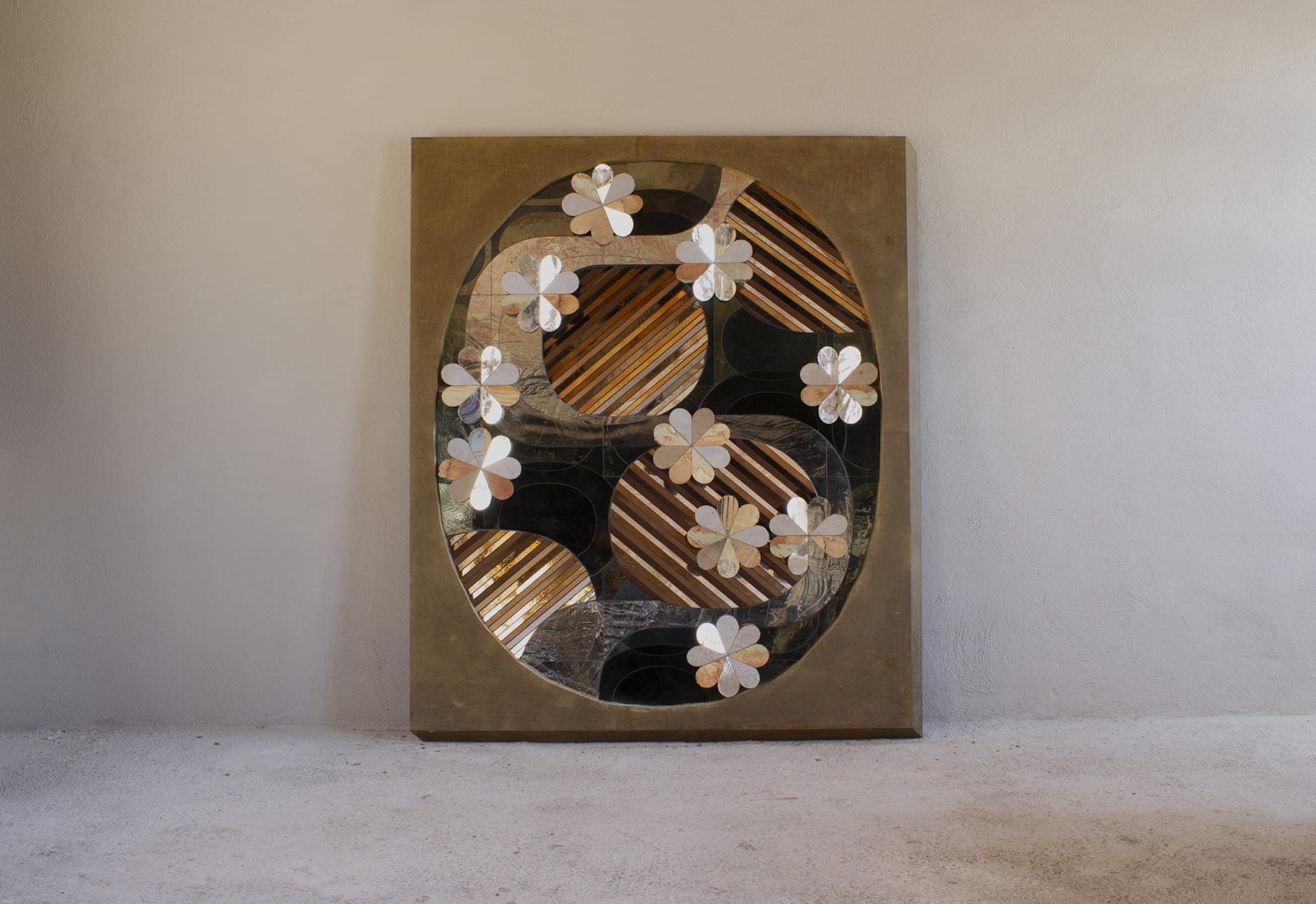 Abstract art piece featuring floral motifs and geometric patterns on a large canvas against a plain background.