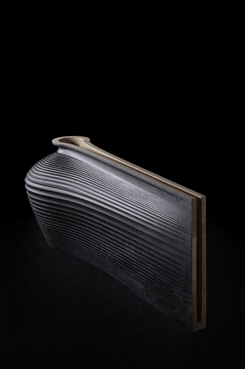 Modern sculptural bench with wave-like wooden design set against a dark background, showcasing artistic craftsmanship.