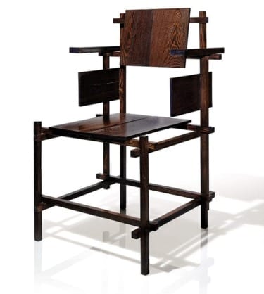 Modern geometric wooden chair with angular design and dark stain on a white background.