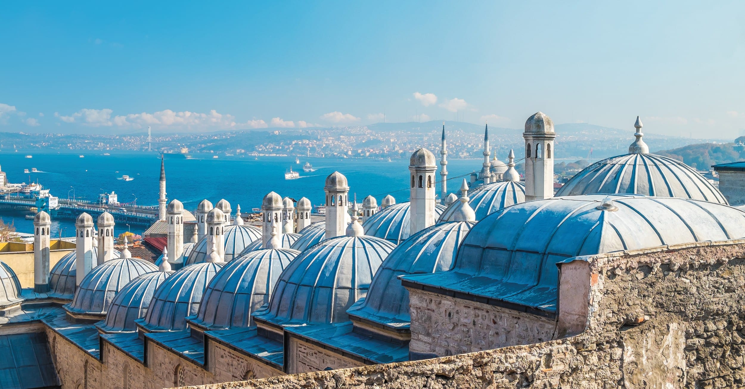 Rooftop domes of Istanbul with a scenic view of the Bosphorus Strait and distant cityscape.