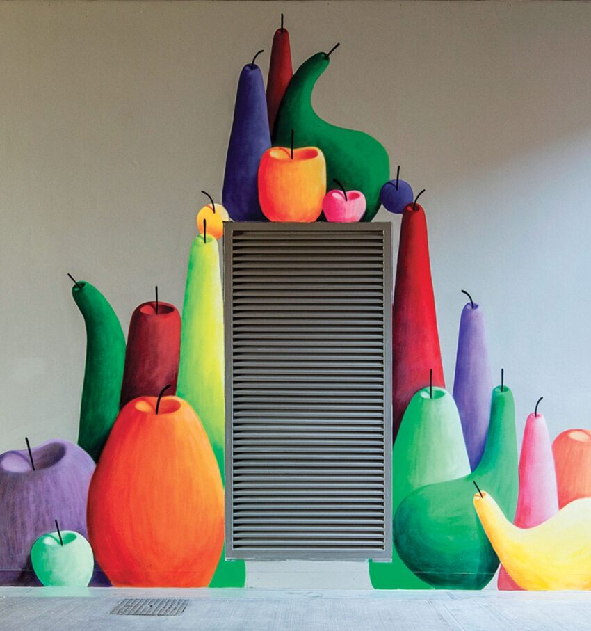 Colorful mural of various vibrant fruits surrounding a gray vent on a wall.