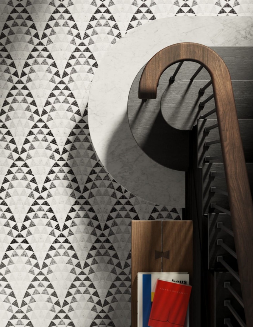Patterned wall with geometric shapes, a spiral staircase, and a wooden rack holding colorful books and magazines.