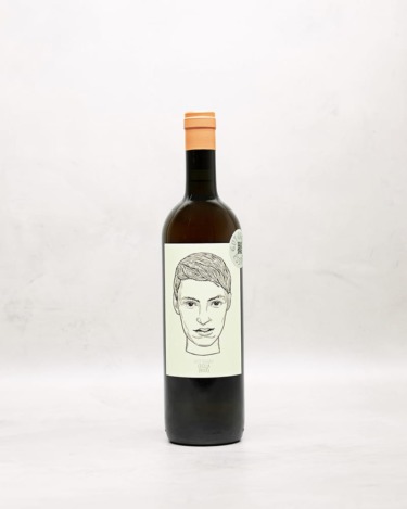 A bottle of wine with an illustration of a person's face on the label, set against a plain background.