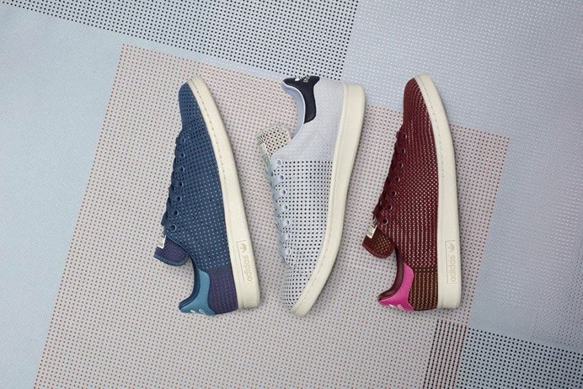 Three pairs of sneakers in blue, white, and red with perforated designs on a patterned background.