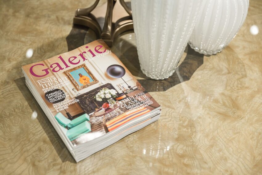 Magazine titled Galerie on a table next to a decorative white vase.