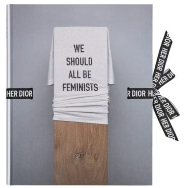 Book titled "Her Dior" with a cover featuring a T-shirt displaying the text "We Should All Be Feminists".