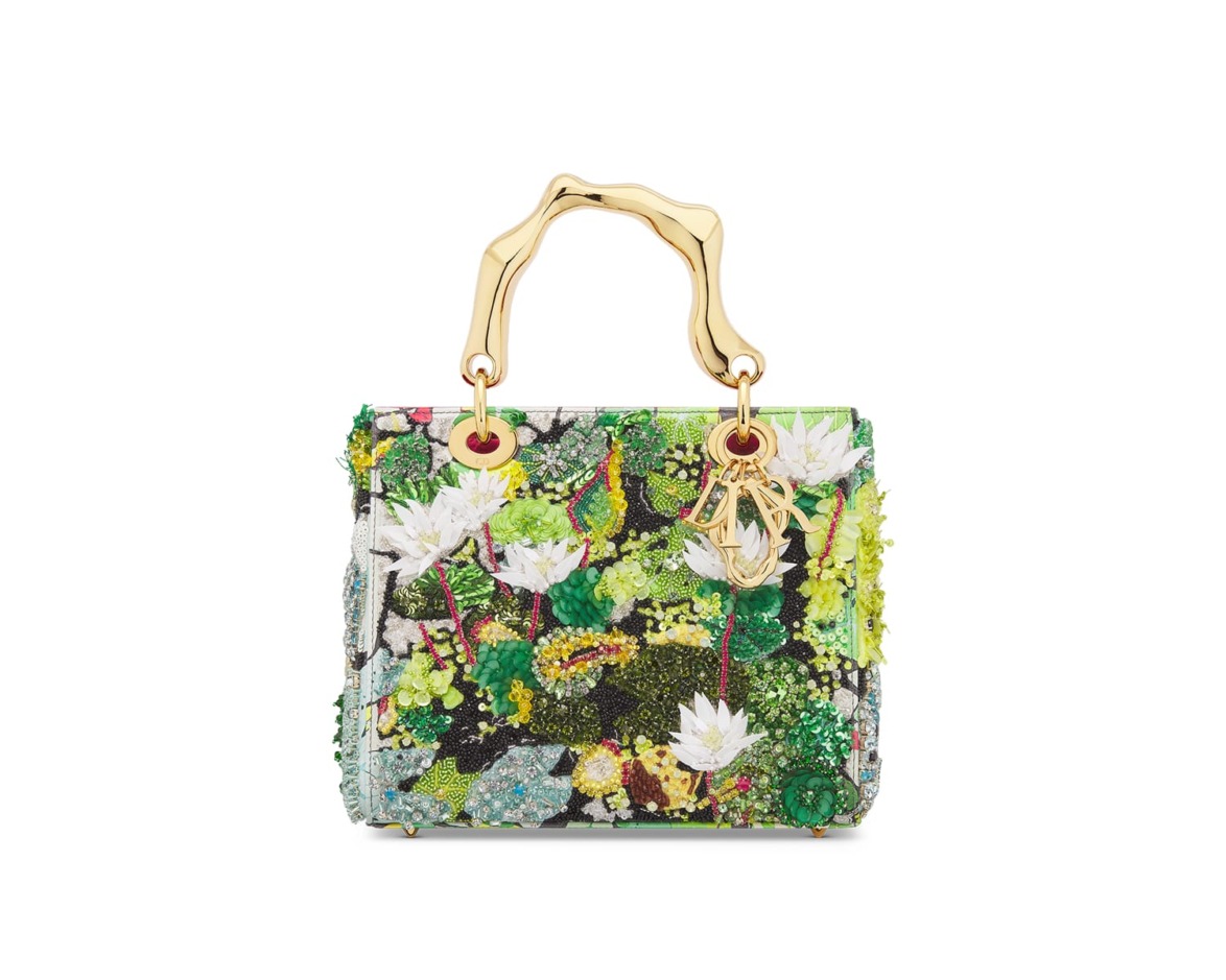 Colorful embroidered handbag with floral pattern and gold handles.