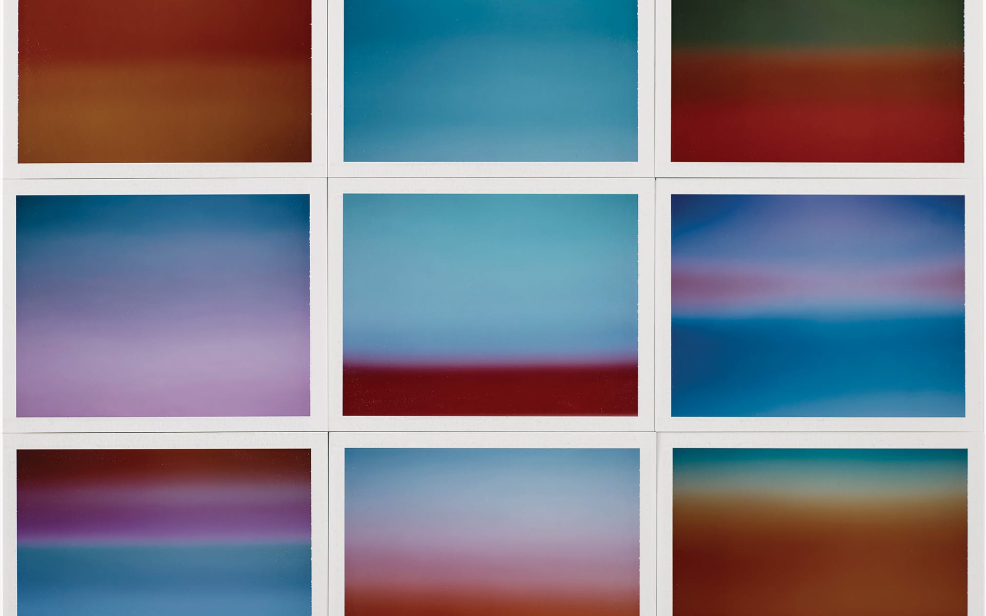 Grid of abstract blurry images featuring a mix of blue, red, purple, and green tones arranged in three rows and columns.