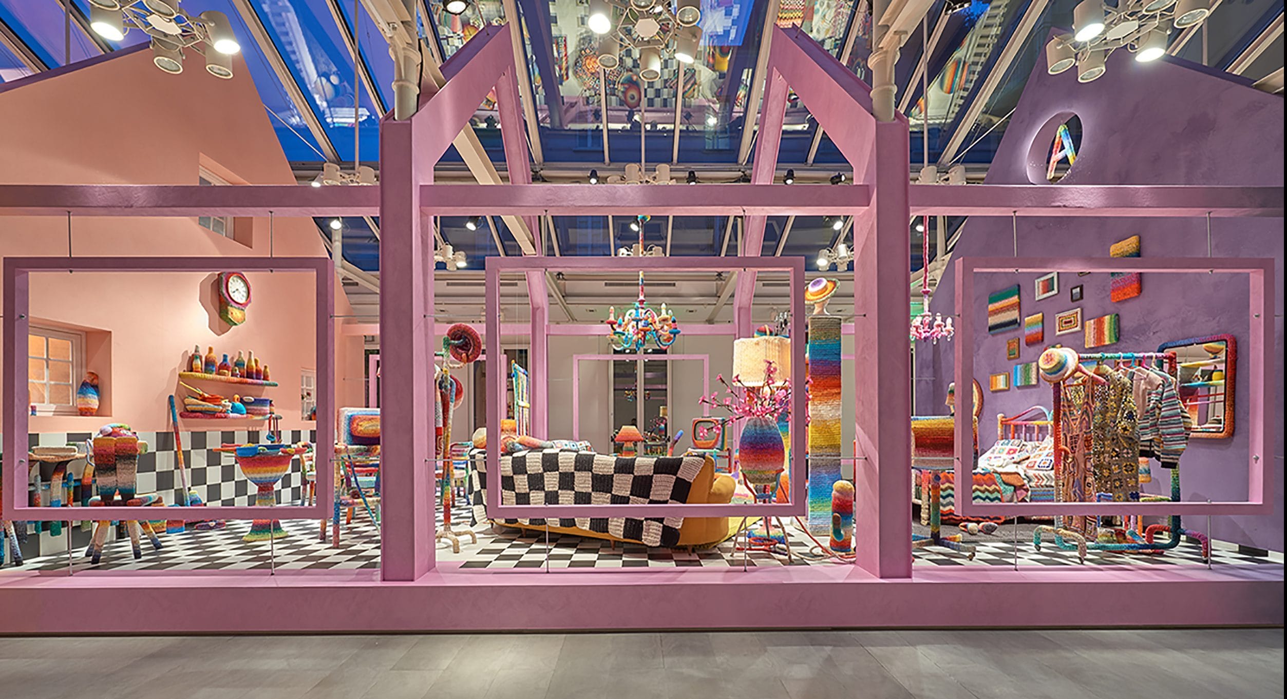 Vibrant, colorful store interior with eclectic decor, checkered floor, and various patterned furnishings under bright lighting.