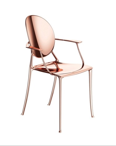 Modern metallic chair with a sleek, reflective design and contoured lines.