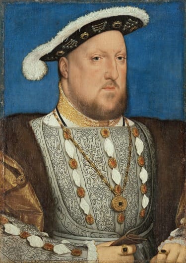 Portrait of a man in regal attire with a jeweled necklace, wearing a black hat against a blue background.