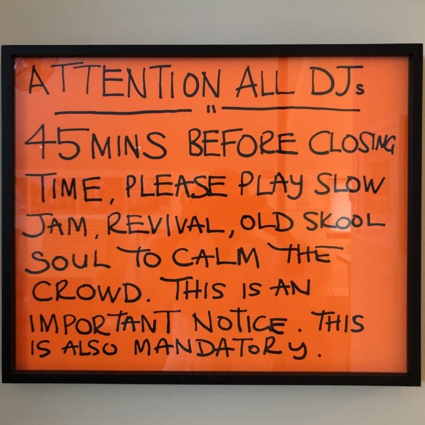 Framed notice for DJs to play slow music 45 minutes before closing to calm the crowd; mandatory instruction.