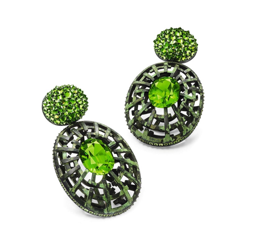 Elegant green gemstone earrings with intricate lattice design and round stud accents.