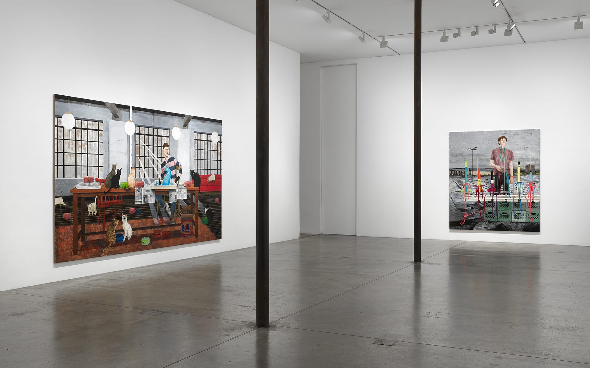 Art gallery interior with two large paintings displayed on white walls, concrete floor, and ceiling track lighting.