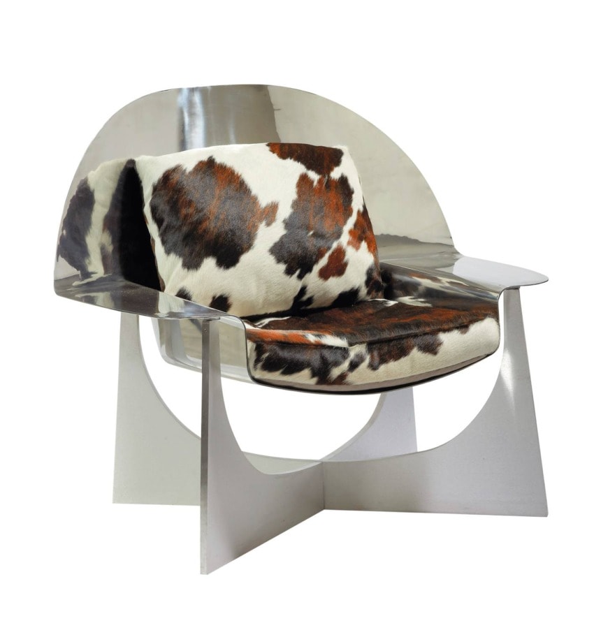 Modern chair with a metallic frame and cowhide cushion, featuring a unique geometric design.