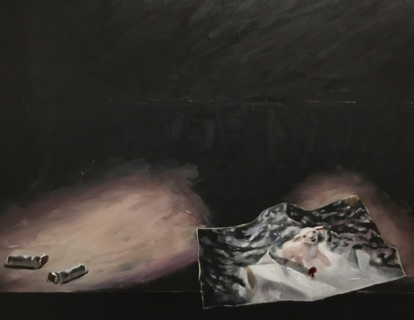 Dark abstract painting with cigarettes and a photo of a sheep on a table.