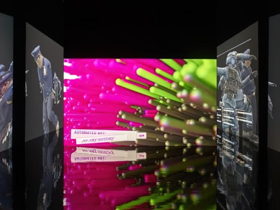 Artistic digital display with vivid colors, featuring abstract shapes and reflections on a glossy floor.