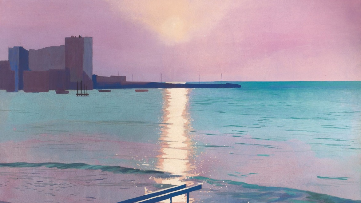 Sunset over a calm sea with a reflection on the water, silhouetted buildings, and a railing in the foreground.