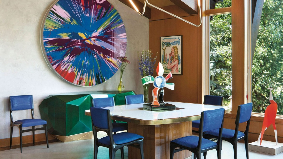 A Damien Hirst Spin painting makes a splashy statement in the dining area of Sue Hostetler’s Aspen home designed by Sara Story.