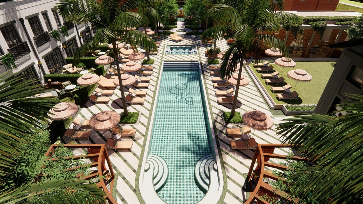 Luxury outdoor swimming pool with sun loungers, umbrellas, and surrounded by lush greenery in a resort-style setting.