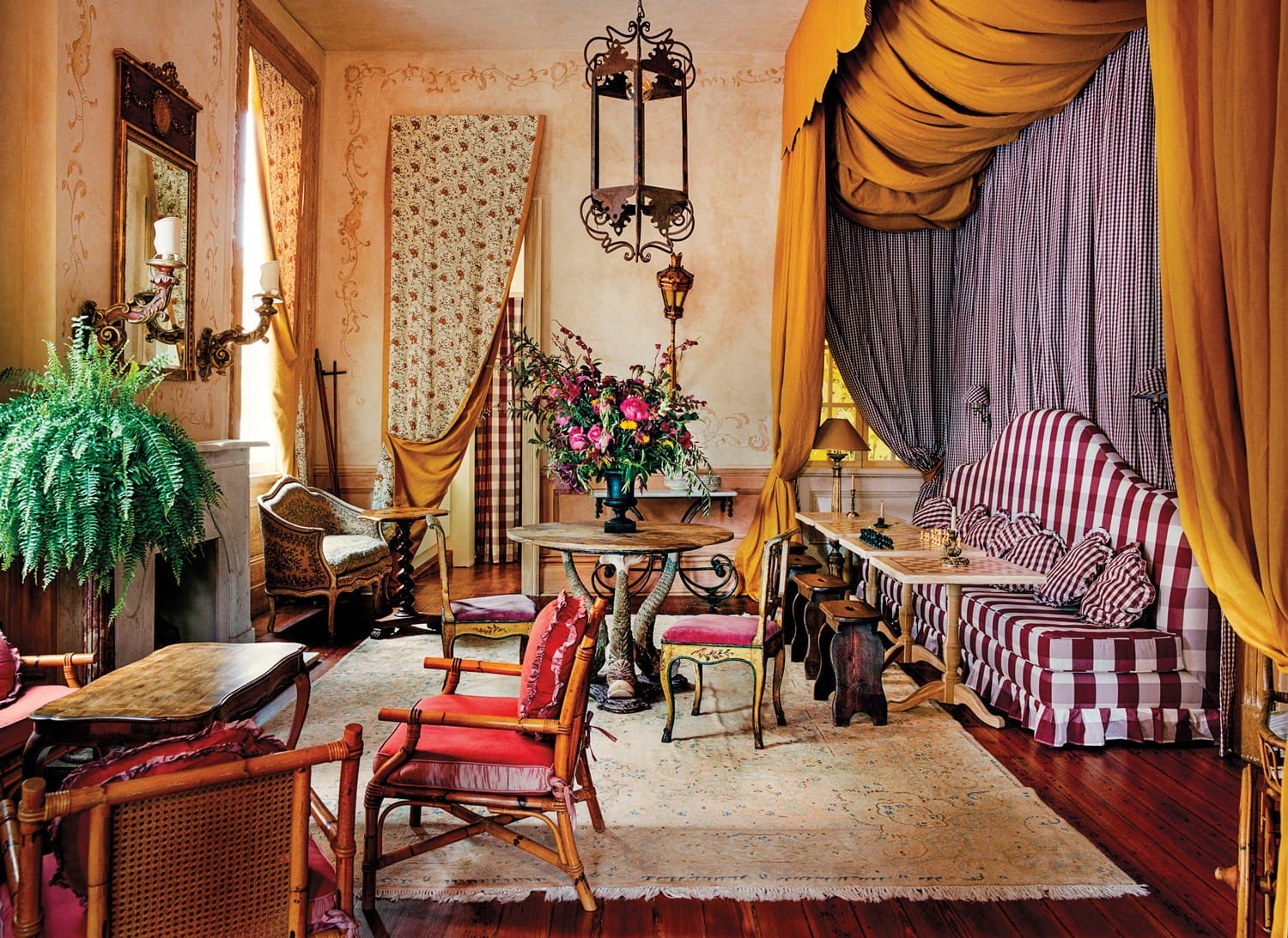 Elegant vintage living room with ornate furniture, striped sofa, floral centerpiece, and decorative curtains.