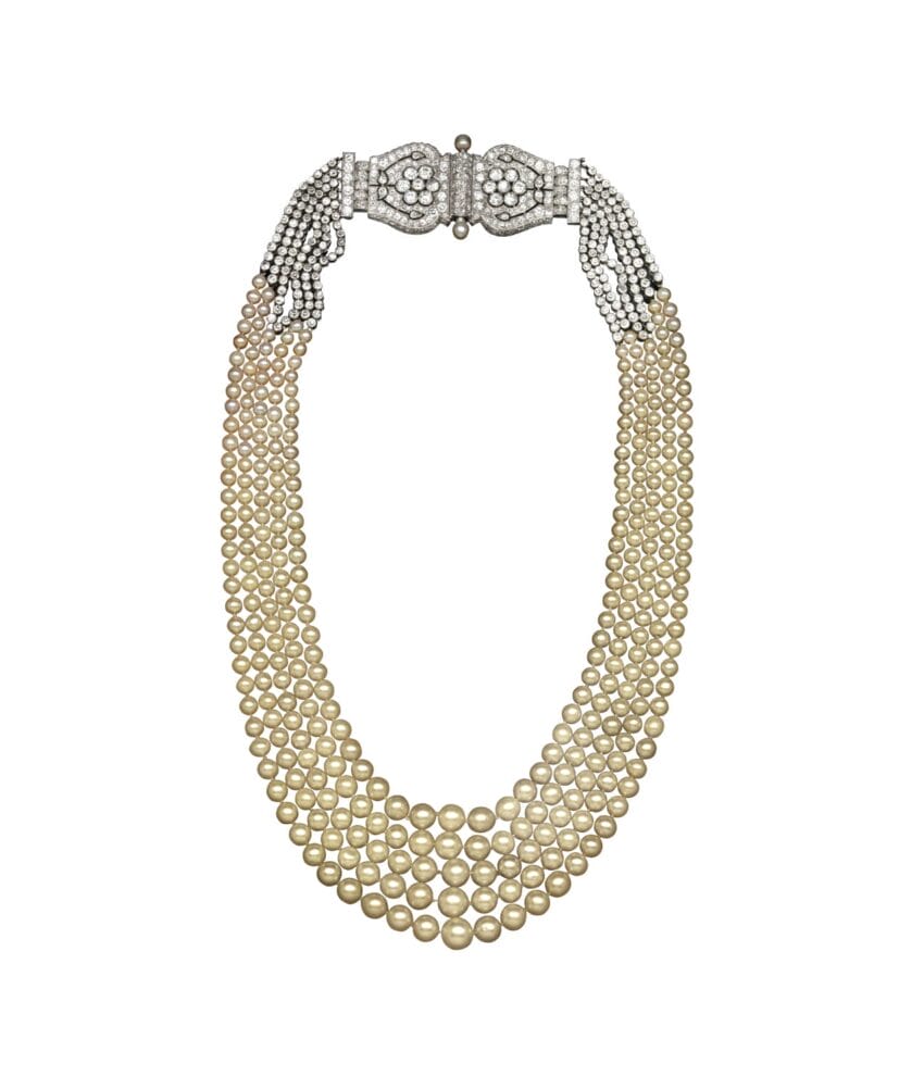 Elegant multi-strand pearl necklace with intricate silver clasp and graduated pearl sizes for formal occasions.