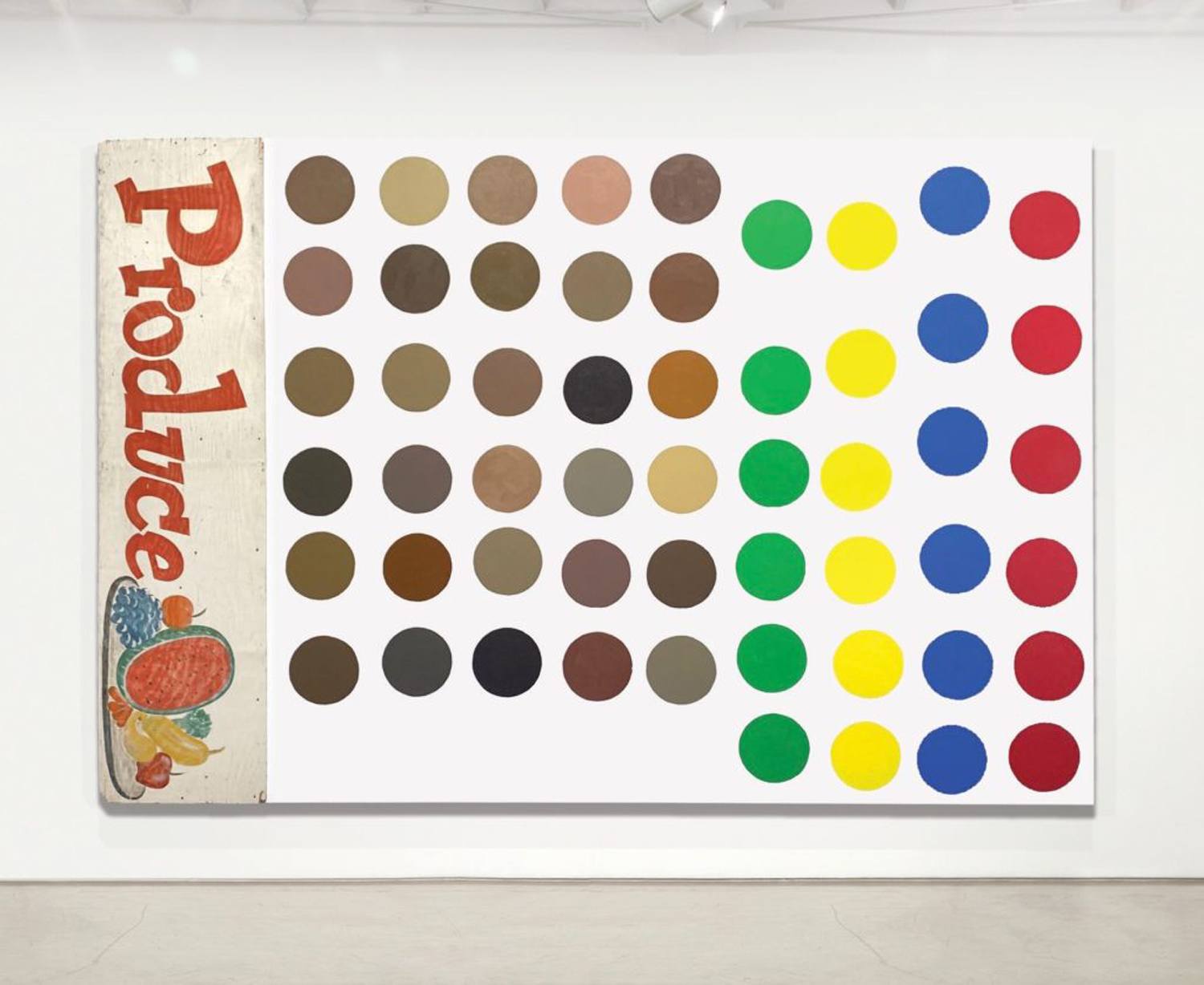 Artwork with grid of colored circles on canvas, labeled "Produce" on the side, displayed in a gallery setting.