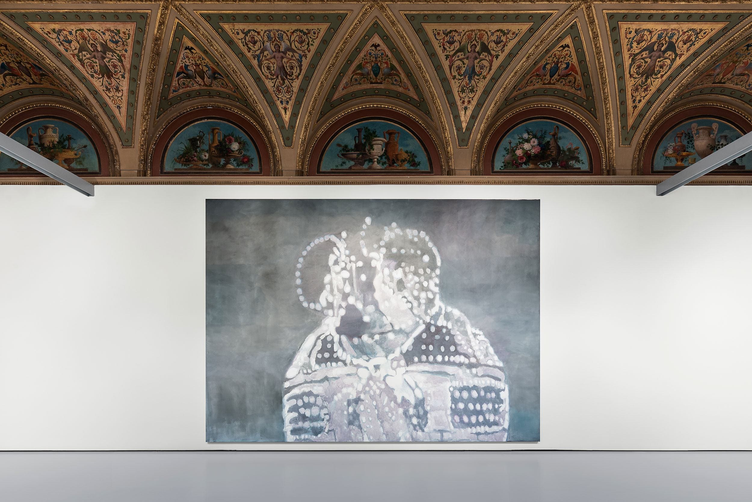 Large painting with abstract figures in a modern gallery, beneath a decorative arched ceiling with classical artwork.