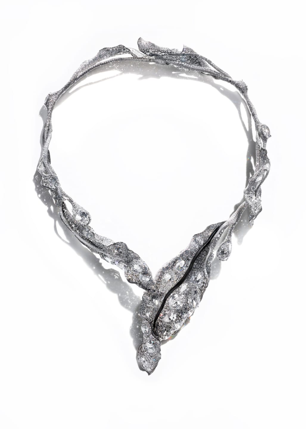 Elegant, intricate silver necklace with organic shapes and sparkling details, resembling entwined branches or vines.