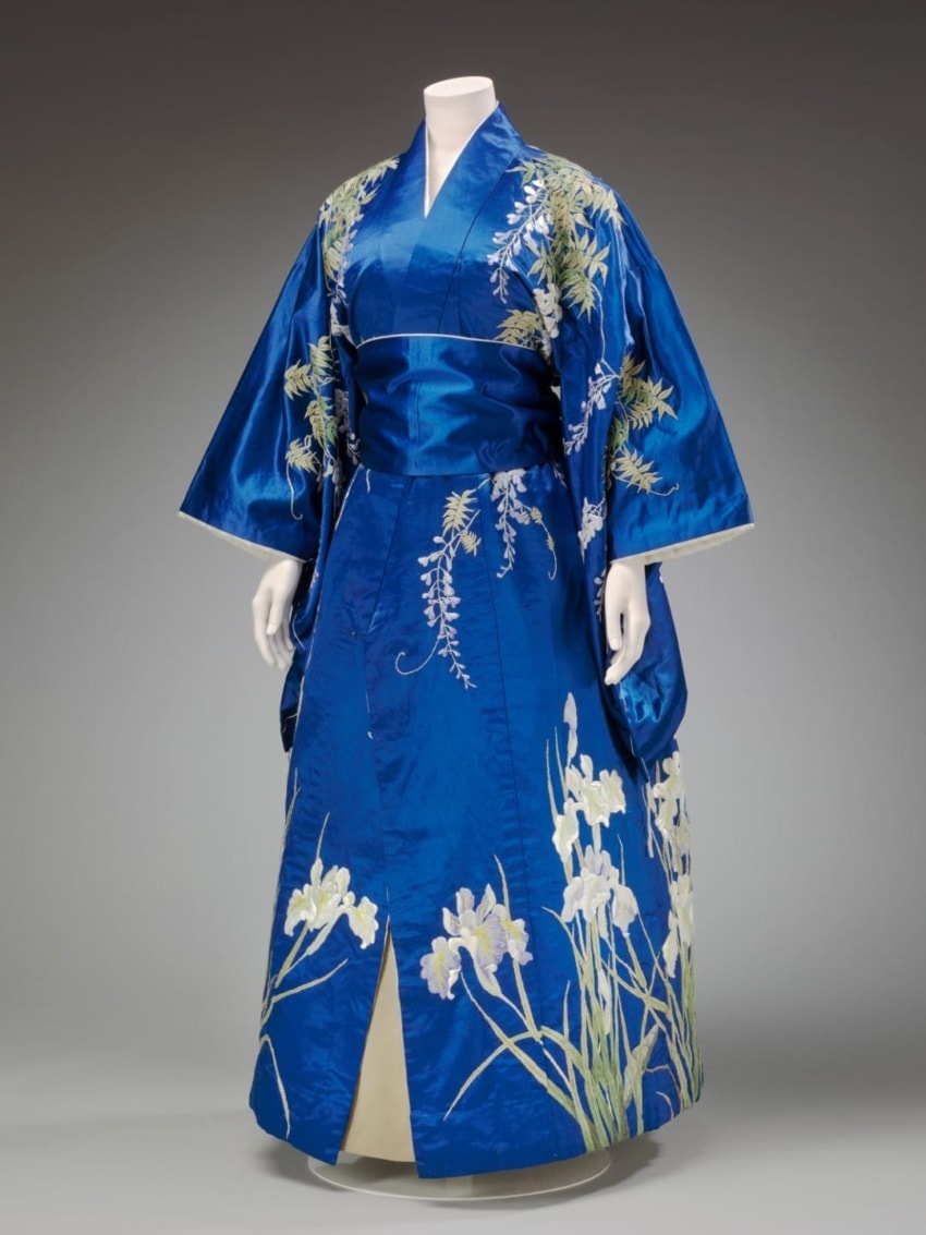 Blue kimono with floral patterns displayed on a mannequin.