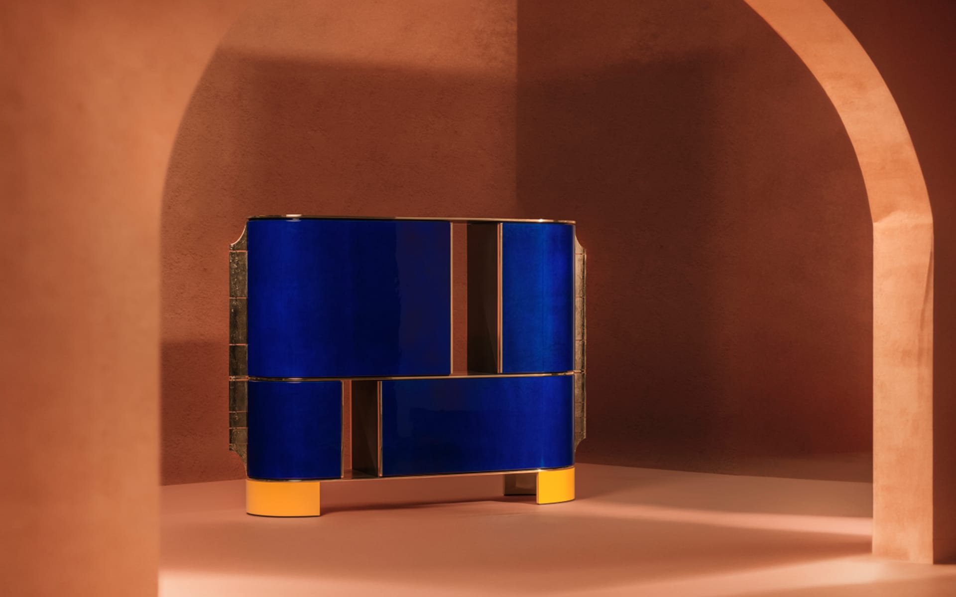Modern blue and gold cabinet set against an arched, earth-toned background in a minimalist setting.