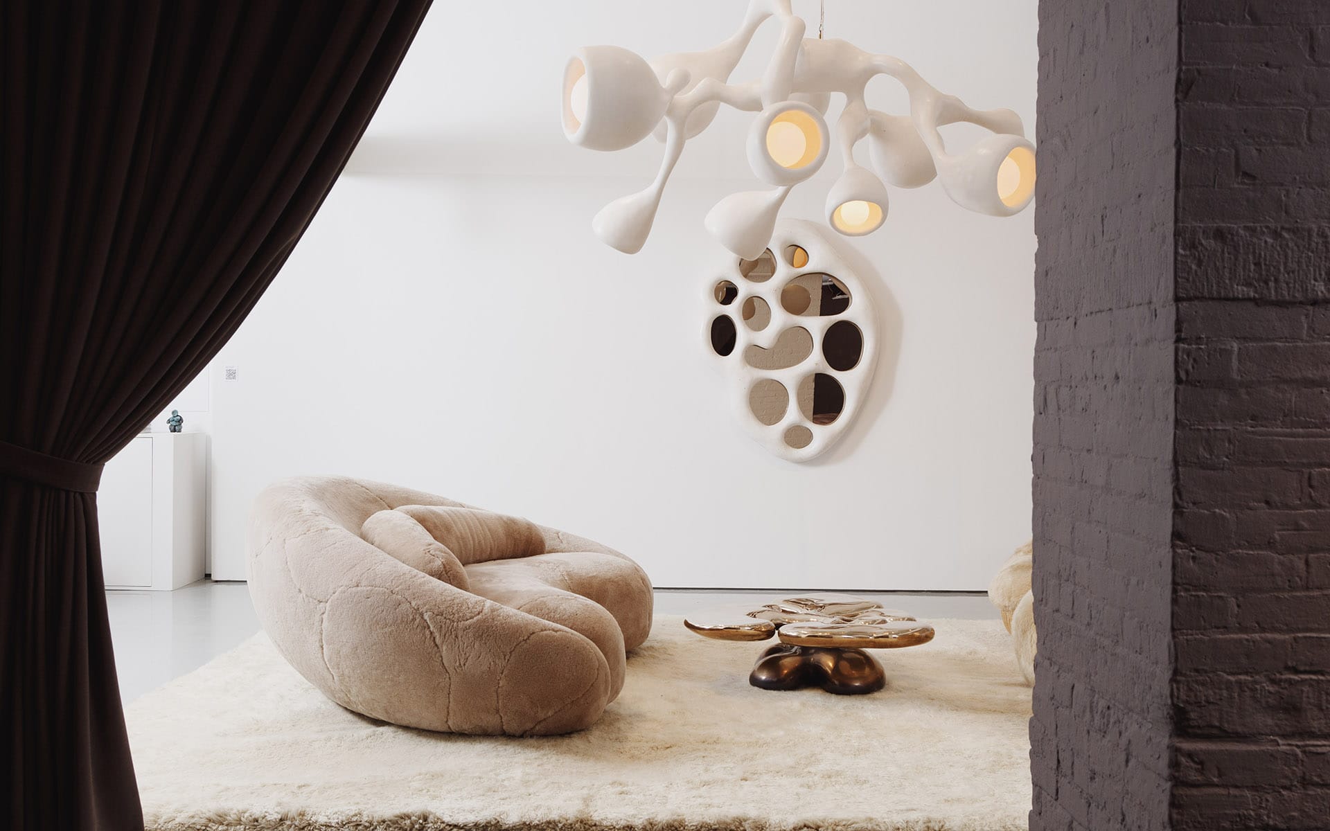 Modern living room with unique beige sofa, abstract chandelier, and artistic wall decor. Cozy and stylish interior design.
