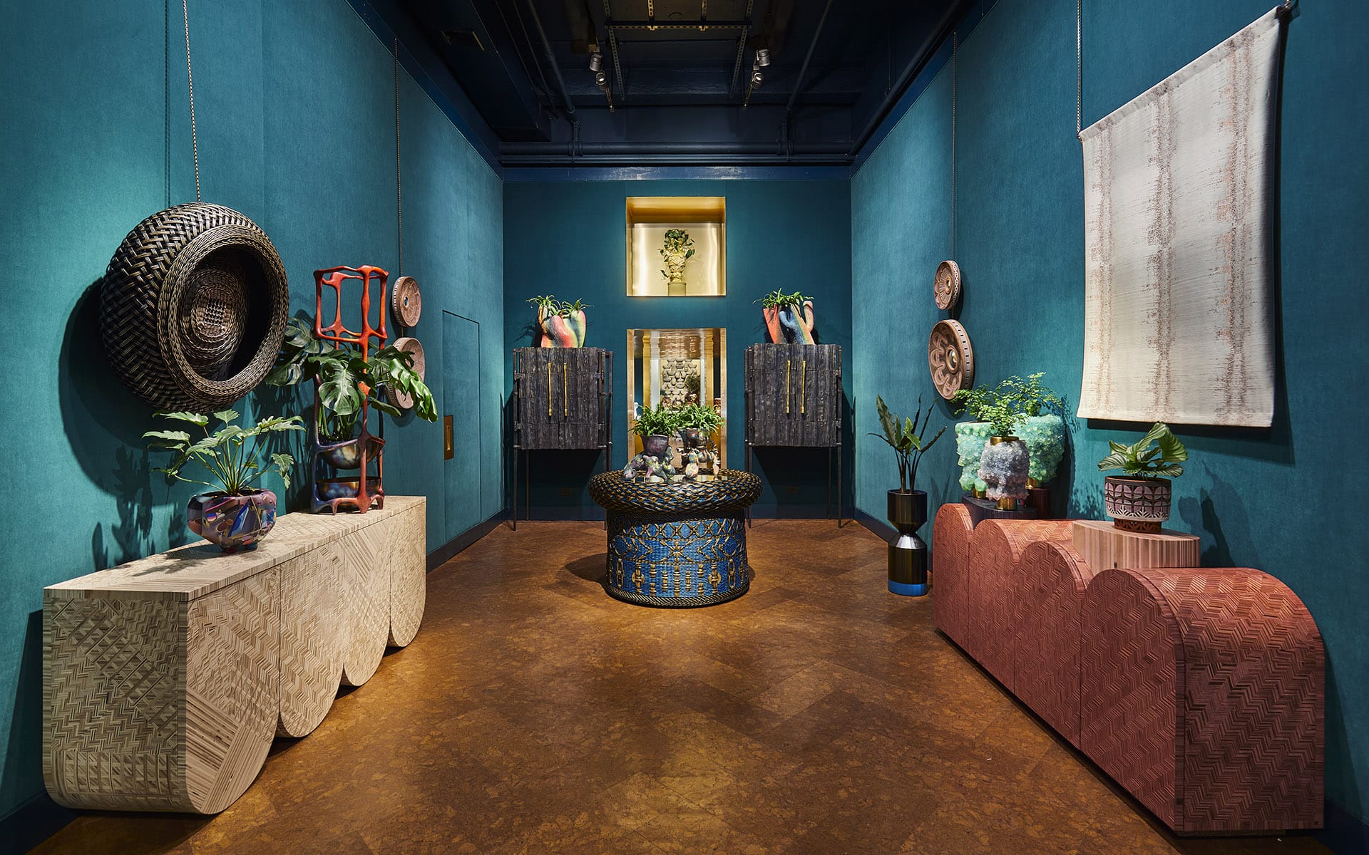 Eclectic room with vibrant blue walls, patterned furniture, plants, and decorative art pieces creating a cozy atmosphere.