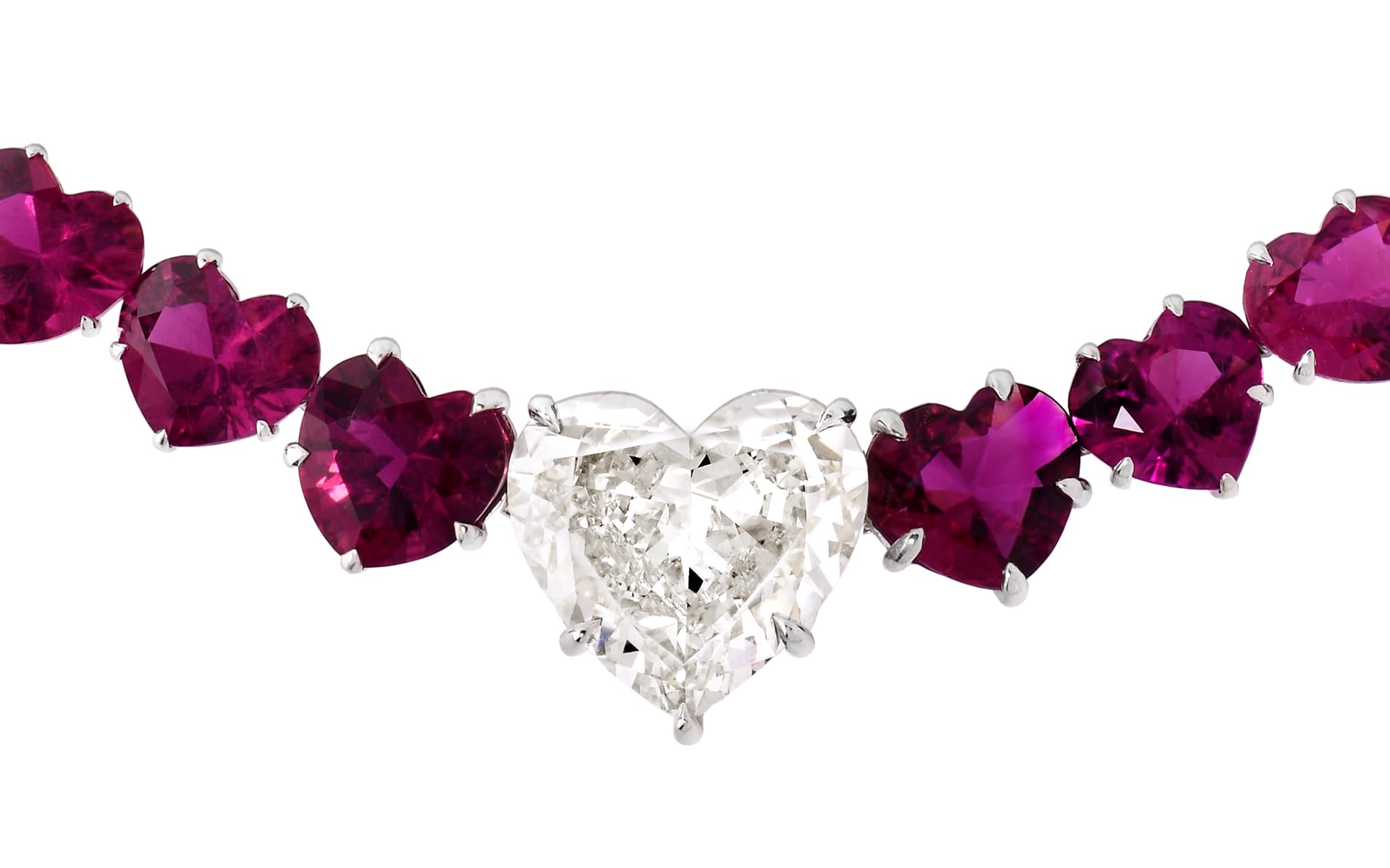 Heart-shaped diamond necklace with red heart-shaped gemstones.