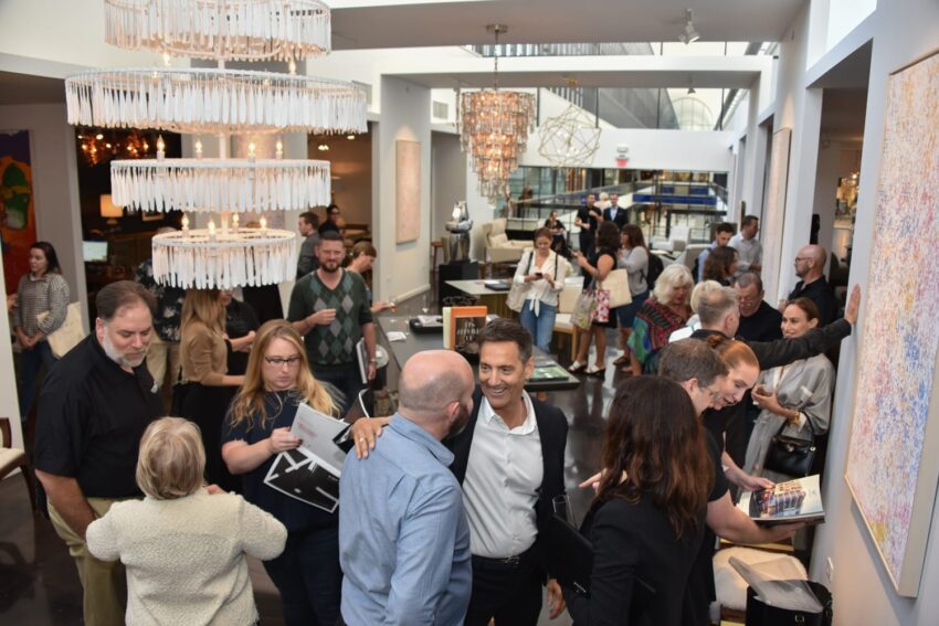 Group of people mingling at an indoor event with modern decor and artwork.