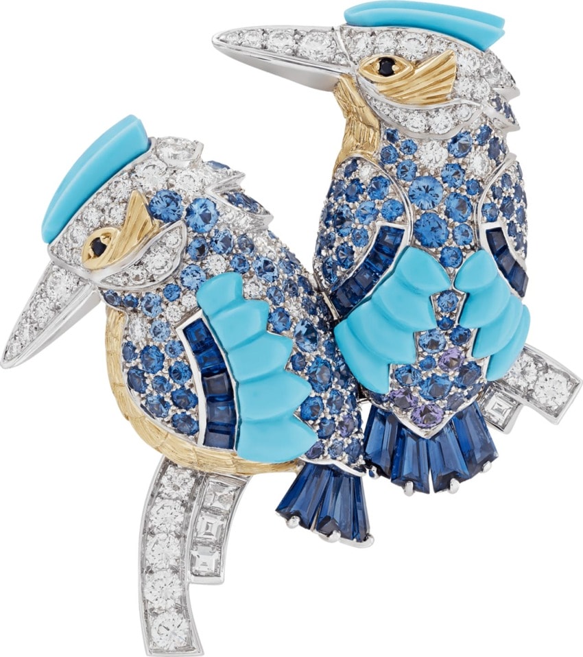 Two jeweled kookaburra brooches with blue and gold detailing, featuring intricate gemstone patterns on a white background.