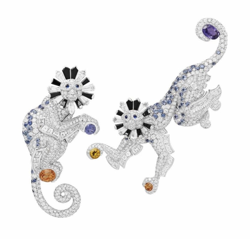Intricate, jeweled lion and panther brooches with diamonds, sapphires, and colored gemstones in an elegant design.