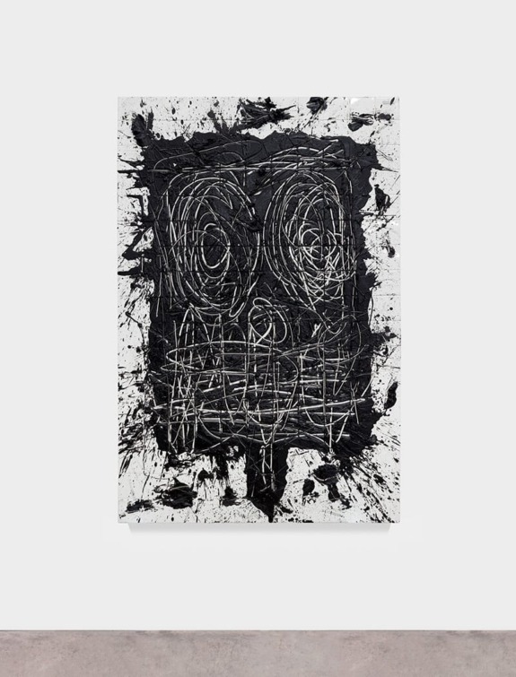 Abstract black and white painting with swirling patterns and grid-like lines displayed on a plain wall.