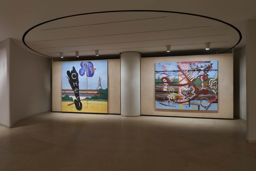 Art installations displayed on large canvases in a modern gallery setting with overhead lighting.