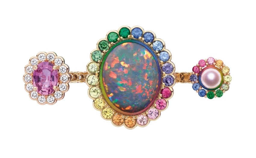 Colorful opal ring with gemstones and pearls in gold setting, featuring vibrant hues of pink, blue, green, and orange.