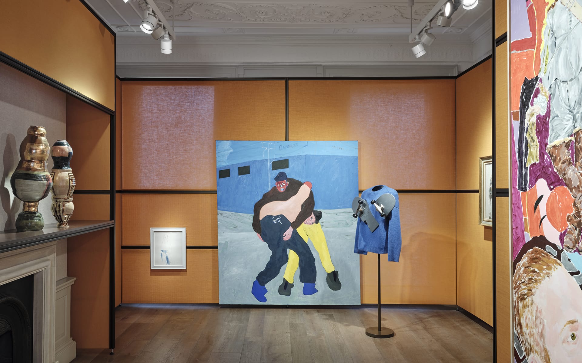 Art gallery interior featuring contemporary paintings and vases, with a focus on a large central artwork on an orange wall.