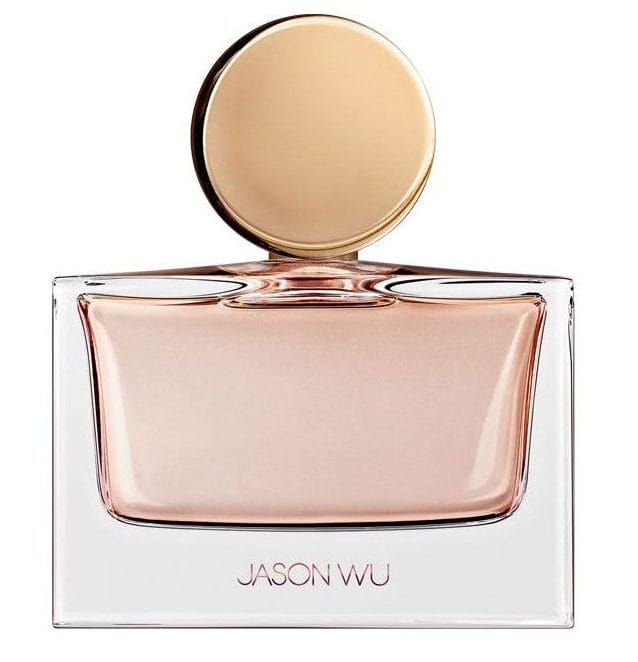Elegant perfume bottle with a round gold cap and transparent design, featuring the brand name on the front.