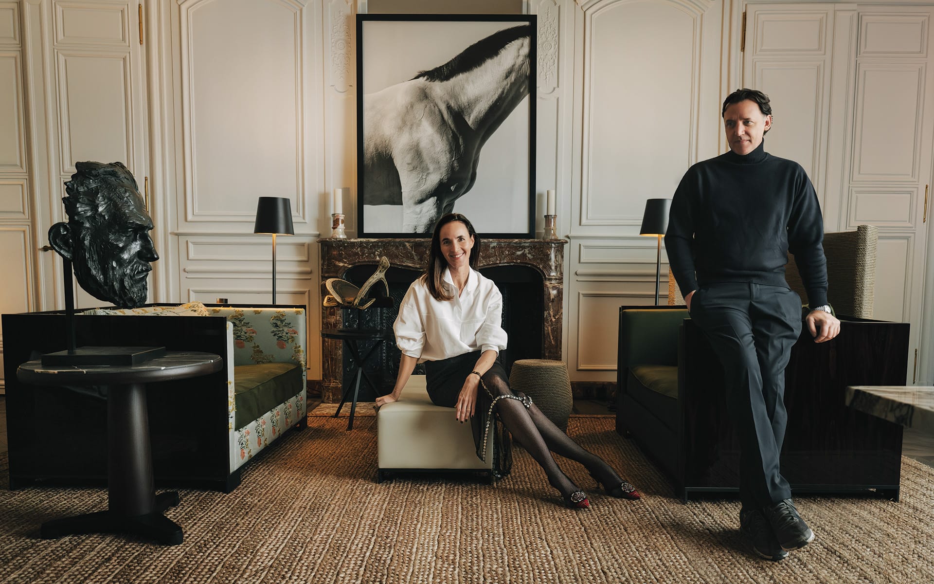 Gilles and Bossier in their Paris residence with a sculpture by Christophe Charbonnel (left) and a photograph by Steven Klein.