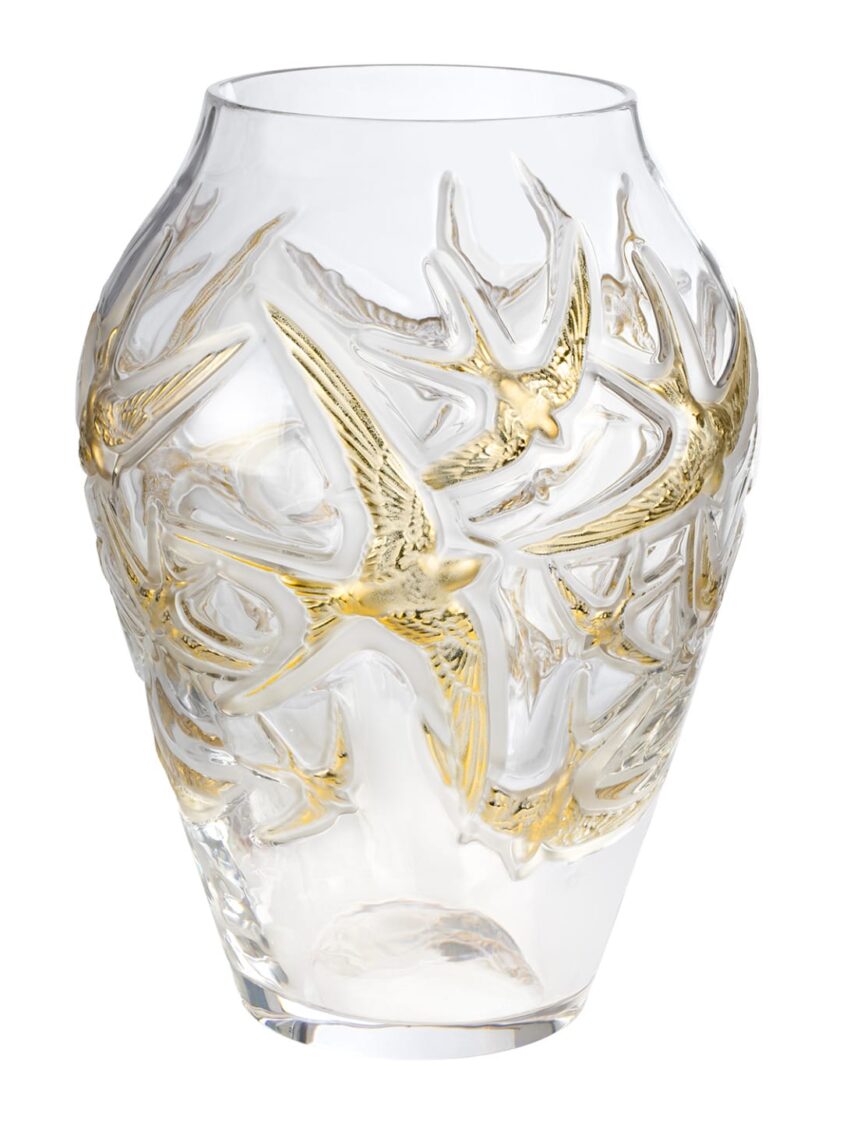 Clear glass vase with intricate gold bird design wrapping around its surface.