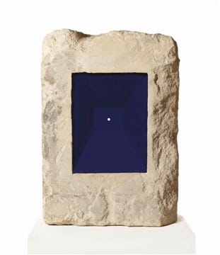 Stone sculpture with deep blue recessed center featuring a small white circle on a white base.