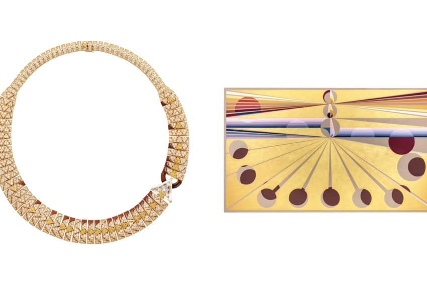Gold necklace with diamond accents next to an abstract painting featuring geometric shapes and lines in gold and red tones.