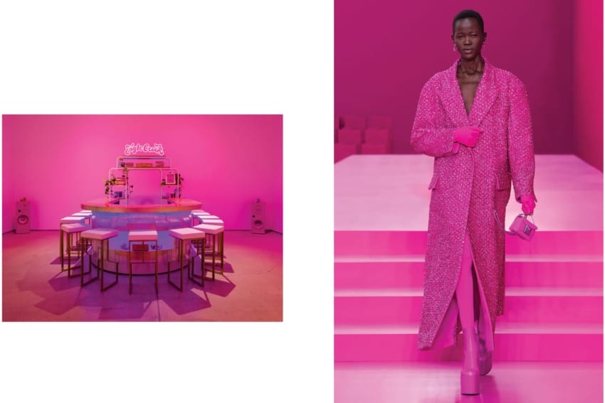 Trendy pink fashion runway with a model in a glittery coat and vibrant pink setup with stools and a neon sign in the background.